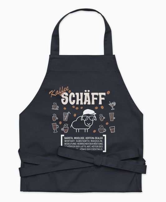 Dunkelblaue Premium Kaffee SCHÄFF Kochschürze aus Bio-Baumwolle mit witzigem Wörterbuch-Design und zwei großen Vordertaschen auf weißem Hintergrund.