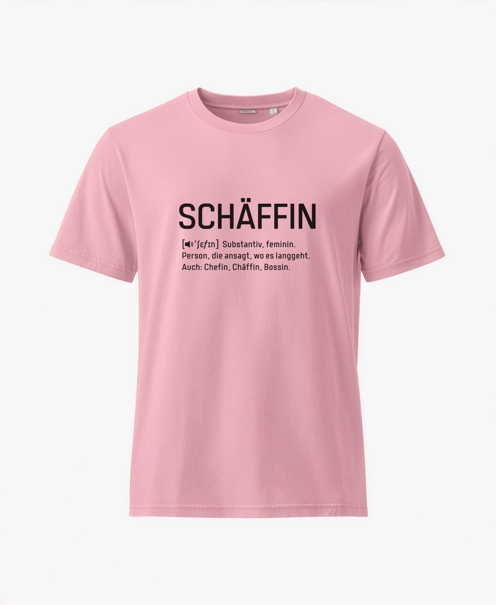 Pinkfarbenes T-Shirt mit schwarzem Frontaufdruck im Wörterbuch-Stil: SCHÄFFIN – Substantiv, feminin. Person, die ansagt, wo es langgeht. Auch: Chefin, Chäffin, Bossin.