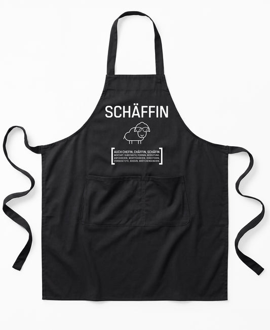 SchwarzePremium SCHÄFFIN – Chefin Schürze Classic aus Bio-Baumwolle mit witzigem Wörterbuch-Design und zwei großen Vordertaschen.