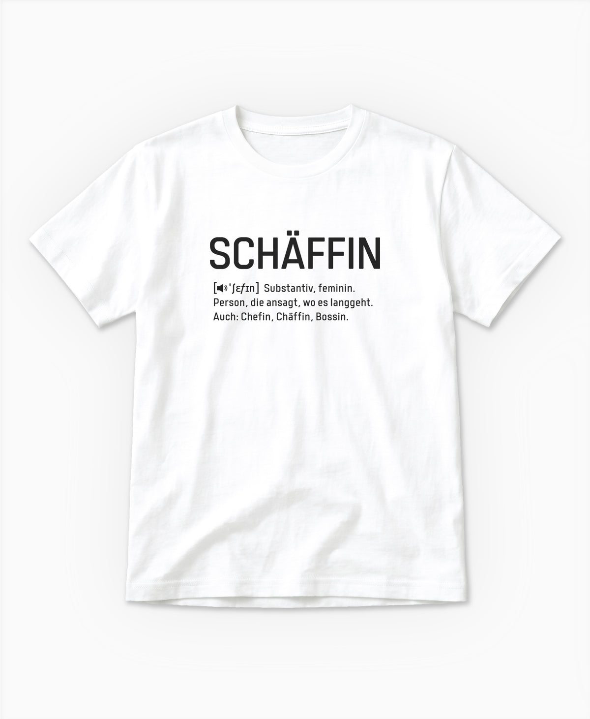 Weisses T-Shirt mit schwarzem Frontaufdruck im Wörterbuch-Stil: SCHÄFFIN – Substantiv, feminin. Person, die ansagt, wo es langgeht. Auch: Chefin, Chäffin, Bossin.
