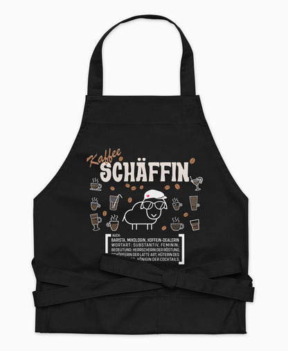 Schwarze Premium Kaffee SCHÄFFIN Kochschürze aus Bio-Baumwolle mit witzigem Wörterbuch-Design und zwei großen Vordertaschen auf weißem Hintergrund.