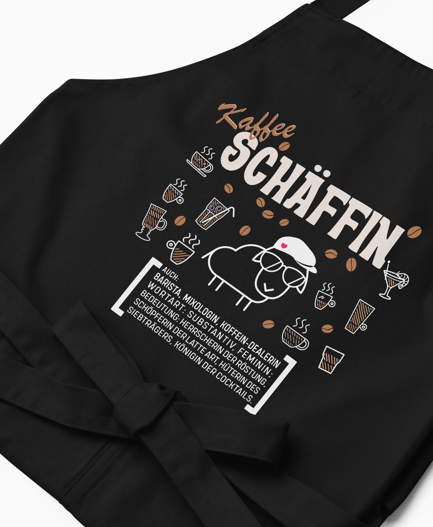 Nahaufnahme der schwarzen Kaffee SCHÄFFIN Kochschürze mit detailreichem, braun-weißem Aufdruck.