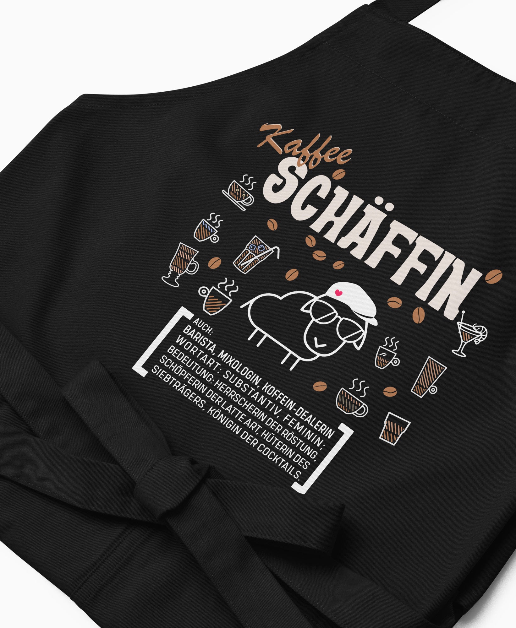 Nahaufnahme der schwarzen Kaffee SCHÄFFIN Kochschürze mit detailreichem, braun-weißem Aufdruck.