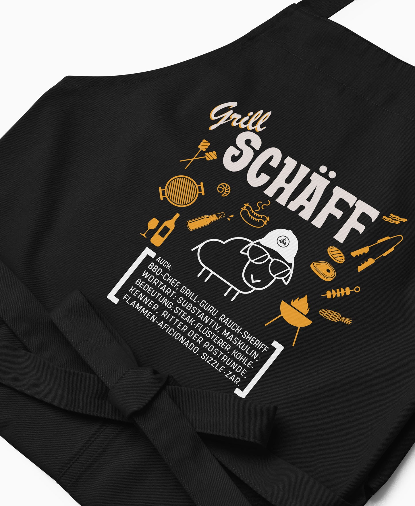 Nahaufnahme der schwarzen Grill SCHÄFF Grillschürze mit detailreichem, orange-weißem Aufdruck.