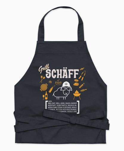 Dunkelblaue Premium Grill SCHÄFF Kochschürze aus Bio-Baumwolle mit witzigem Wörterbuch-Design und zwei großen Vordertaschen auf weißem Hintergrund.