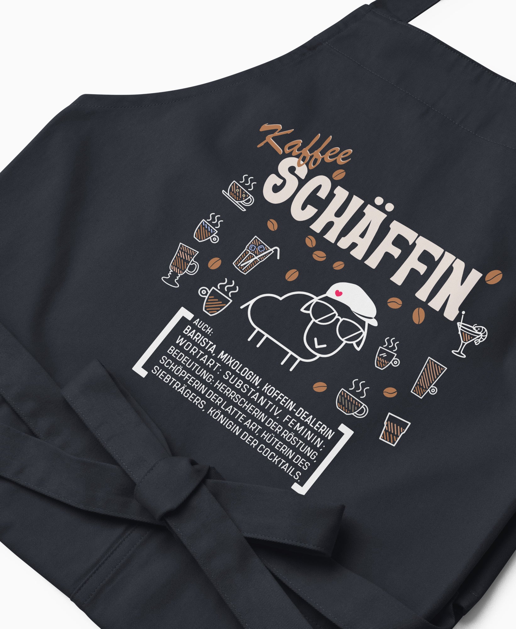 Nahaufnahme der dunkelblauen Kaffee SCHÄFFIN Kochschürze mit detailreichem, braun-weißem Aufdruck.
